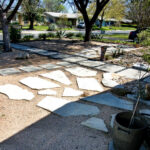 This image depicts the limestone patio made up of several broken limestone pavers placed in a lovely pattern on the crushed granite.