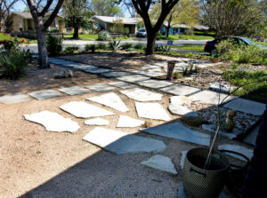 This image depicts the limestone patio made up of several broken limestone pavers placed in a lovely pattern on the crushed granite.