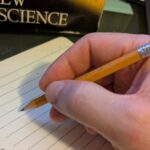 Hand writing on a paper notebook.