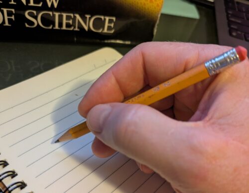 Hand writing on a paper notebook.