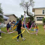 Children playing around maypole