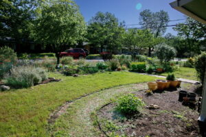 A beautiful view of the curved and colorful front beds near the street.