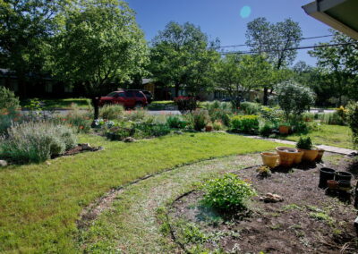 A beautiful view of the curved and colorful front beds near the street.