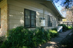 The side of the house displays dwarf nandina with its delicate and lacy foliage.