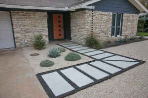 Front Walk, white stone blocks in gray gravel leading to Orange Door