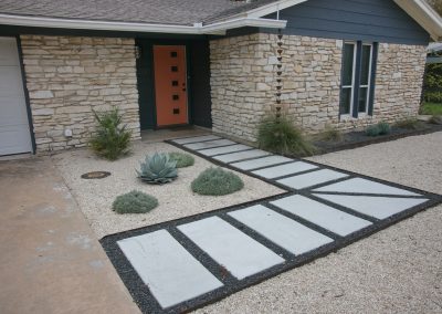 Front Walk, white stone blocks in gray gravel leading to Orange Door