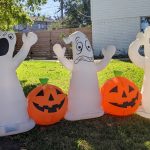 Three blow up ghosts and two jack-o-lanterns